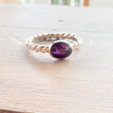 Red oval ring with twisted band